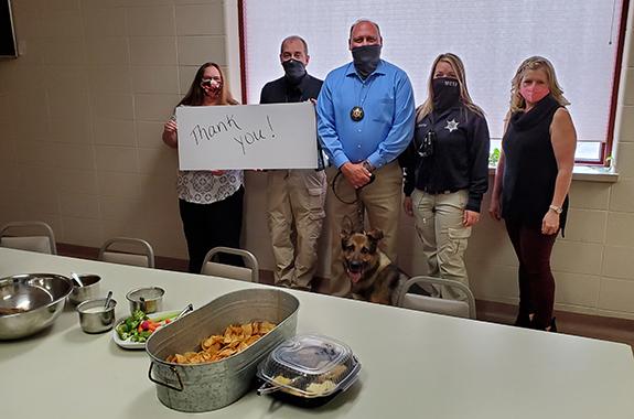 Pictured from left to right are Administrative Professional Darlene Mastricola, Lt. Ryan McElroy, Sheriff Wally Zuehlke and K9 Argo, Dispatcher Kim Gustin, and Medical Examiner Amanda Thoma.